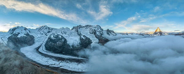 Panorama of the iconic Gornergrat Gletscher, Monte Rosa and Matterhorn in a foggy morning, Zermatt, Canton of Valais, Switzerland