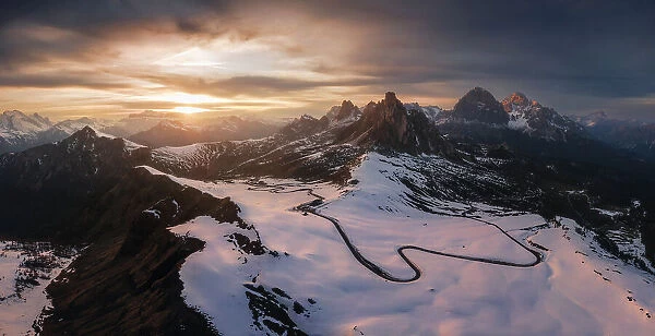 A panoramic aerial view taken from the Giau Pass during an early spring sunset. Dolomites, Italy