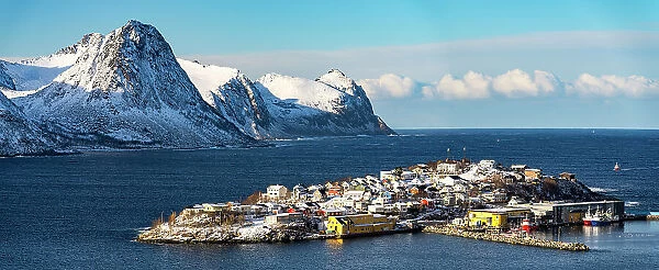 Panoramic of Husoy island and small harbor in between sea and snowy mountains, Senja, Troms county, Norway