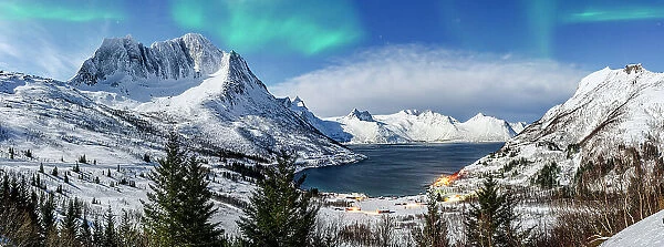 Panoramic of snowy mountains and cold sea under the Northern Lights, Mefjorden, Senja, Troms county, Norway