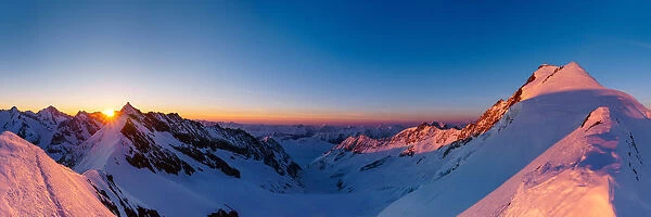 Panoramic view of Aletschorn at sunrise with red light. Aletschorn, Vallese