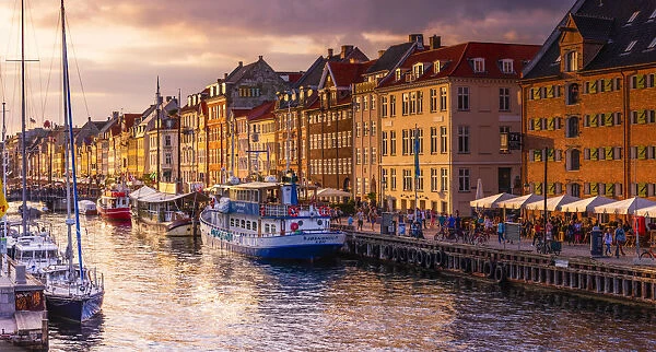 Panoramic view of Nyhavn water canal at sunset in Copenhagen, Denmark