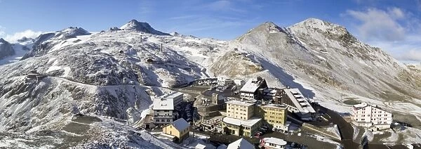 Panoramic view from the Stelvio pass, with a little of snow, and houses and hotels on the Pass