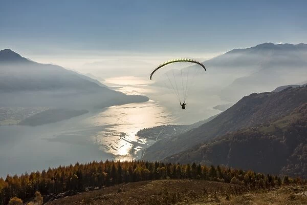 Paragliding over Lake Como and the surroundings mountains. Alto Lario, Como, Lombardy