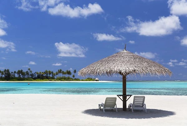 Parasol and sunloungers at Olhuveli Beach and Spa Resort, South Male Atoll, Kaafu Atoll