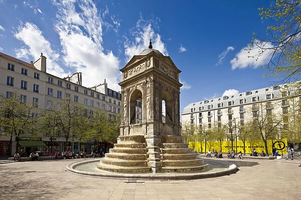 Paris, France. The sun shines on the Fountain des Innocents in the Place Joachim du