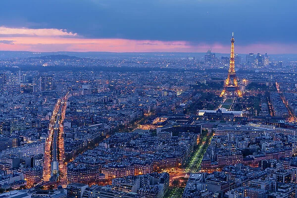 Paris by night from above, streets and Tour Eiffel illuminated after sunset. France