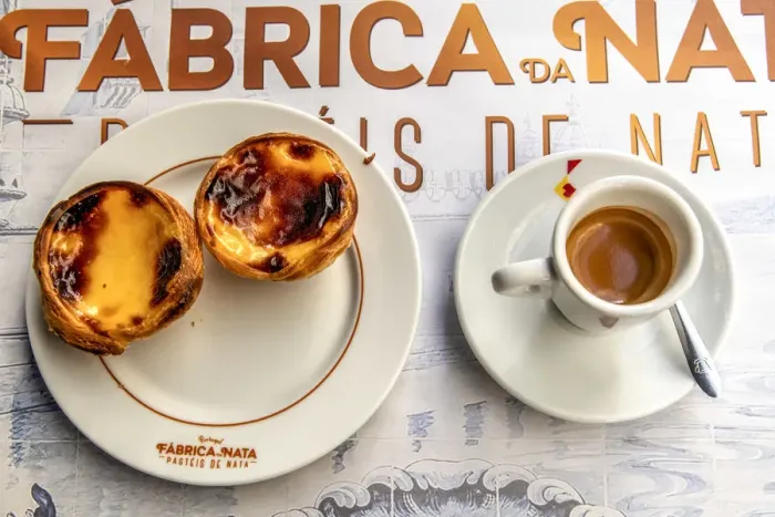 Framed Print : Pastel de belem or pasteis de nata custard tarts served with a cup of coffee in a Framed Print : Pastel de belem or pasteis de nata custard tarts served with a cup of coffee in a