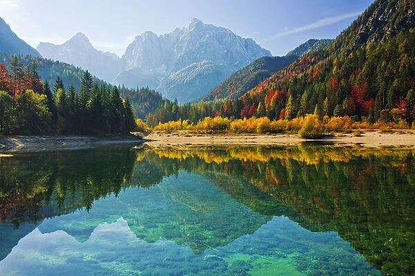Peaks of Prisojnik and Razor reflected in pools beside the Velika Pisnca River in Autumn