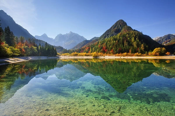 Peaks of Prisojnik and Razor reflected in pools beside the Velika Pisnca River in Autumn