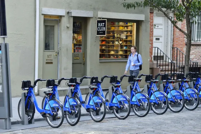 Framed Print : Pedestrian walking past a rack of Citi Bikes on Spring street, in Soho, Manhattan Framed Print : Pedestrian walking past a rack of Citi Bikes on Spring street, in Soho, Manhattan