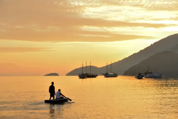 Framed Print : People on dingy paddeling out to ship, cove at Vila do Abrao, Ilha Grande, Rio de Janeiro