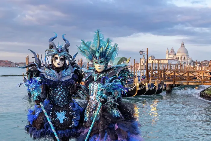 Framed Print : Two people dressed as blue dragons stand by the lagoon during the Venice Carnival, Venice, Italy Framed Print : Two people dressed as blue dragons stand by the lagoon during the Venice Carnival, Venice, Italy