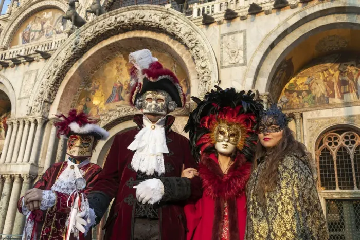Framed Print : Four people dressed up during the Venice Carnival stand in front of the Basilica in St Framed Print : Four people dressed up during the Venice Carnival stand in front of the Basilica in St