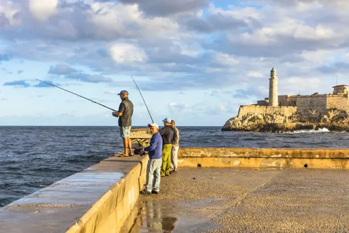Framed Print : People fishing early in the morning on the Malecon, with Castillo De Los Tres Reyes Del Framed Print : People fishing early in the morning on the Malecon, with Castillo De Los Tres Reyes Del