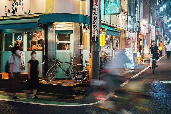 People and neon on the streets of Shimokitazawa in the evening, Tokyo, Japan