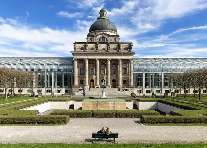 Framed Print : Two people sit opposite the Bavarian State Chancellery, Munich, Bavaria, Germany Framed Print : Two people sit opposite the Bavarian State Chancellery, Munich, Bavaria, Germany