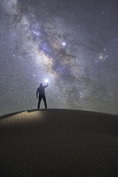 Person admiring the milky way in the sand dunes, Sahara desert, Tunisia, Northern Africa