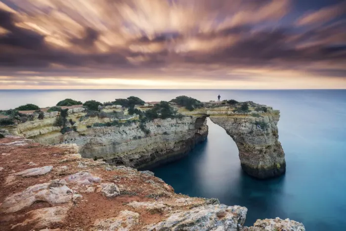 Framed Print : Person on Natural Sea Arch, Praia da Albandeira, Algarve, Portugal Framed Print : Person on Natural Sea Arch, Praia da Albandeira, Algarve, Portugal