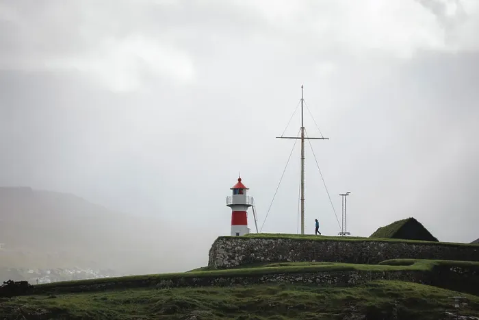 Framed Print : A person walking towards Skansin lighthouse in Torshavn. Faroe Islands Framed Print : A person walking towards Skansin lighthouse in Torshavn. Faroe Islands