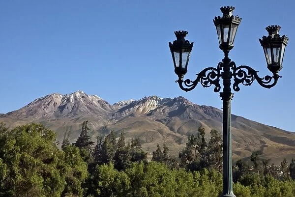Peru, The extinct volcano, Chachani dominates the Arequipa skyline. Many buildings are built with sillar, stone mined from
