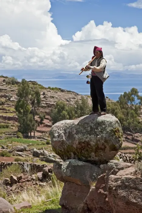 Framed Print : Peru, A Quechua-speaking man plays his flute on Taquile Island. The 7-sq-km island has a population of around