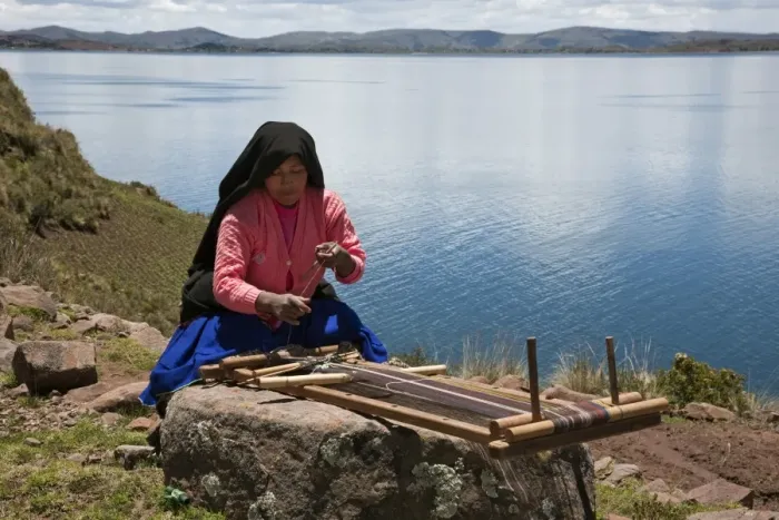 Framed Print : Peru, A Quechua-speaking woman works her traditional wooden loom on Taquile Island Framed Print : Peru, A Quechua-speaking woman works her traditional wooden loom on Taquile Island