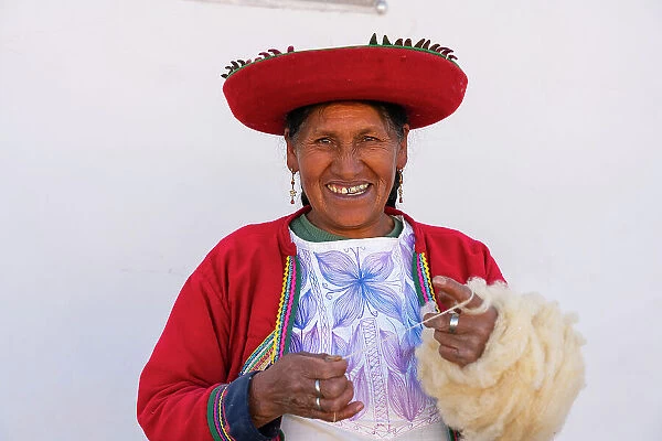 Peruvian woman in traditional dress winding up wool, Chinchero, Sacred Valley, Urubamba Province, Cusco Region, Peru