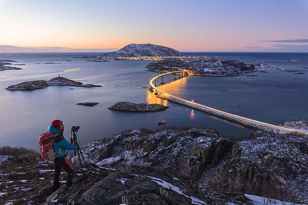 Photographer looks towards bridge and sea, Sommaroy island, Troms county, Norway (MR)