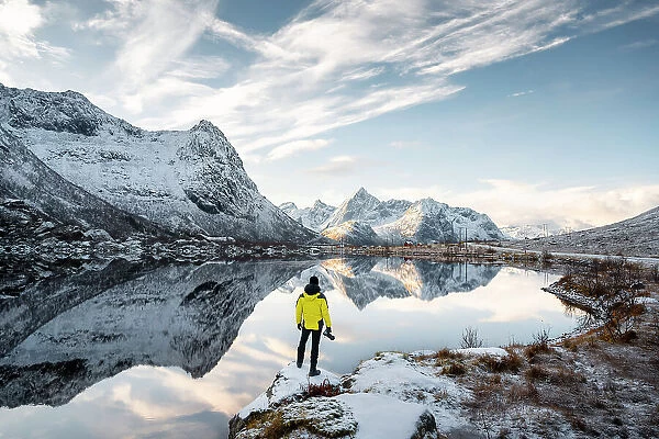 A photographer observes reflections of mountains in Storvatnet near Vareid, Flakstad, Moskenesoya, Nordland, Lofoten Islands, Norway (MR)
