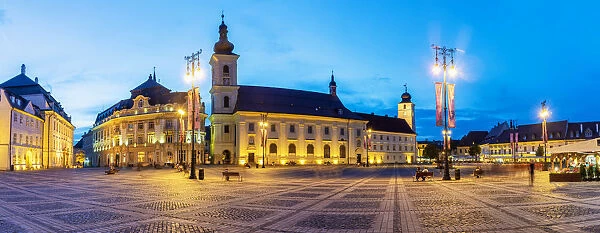 Piata Mare and the Holy Trinity Roman Catholic Church at dusk. Sibiu, Transylvania