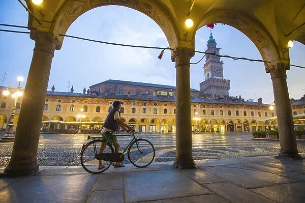 Piazza Ducale, Vigevano, Lombardy, Italy. Rainy sunset and people