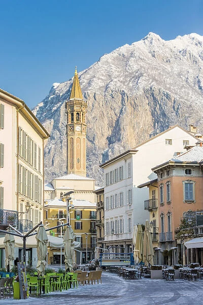 Piazza XX settembre and the iconic bell tower of Lecco with San Martino mount in the