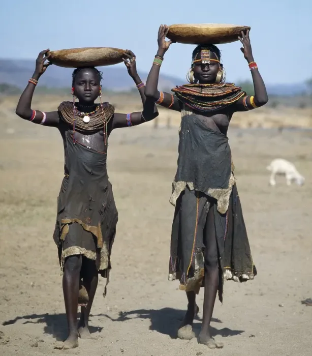 Framed Print : Two Pokot girls carry water in wooden containers on their heads Framed Print : Two Pokot girls carry water in wooden containers on their heads