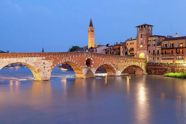 Ponte Pietra and Basilica of Saint Anastasia bell tower at dusk from from Ponte Pietra. Verona, Veneto, Italy