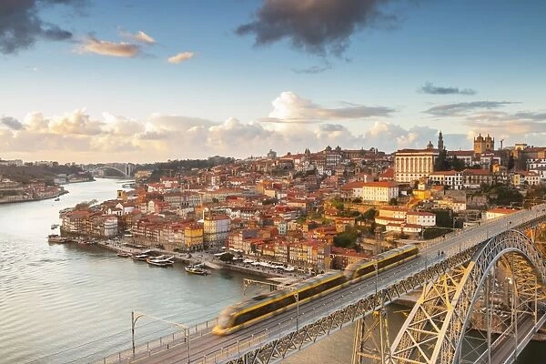 Porto at sunset with a train on Louis I ∞ bridge on Douro River. Oporto city, Porto district, Portugal, Europe