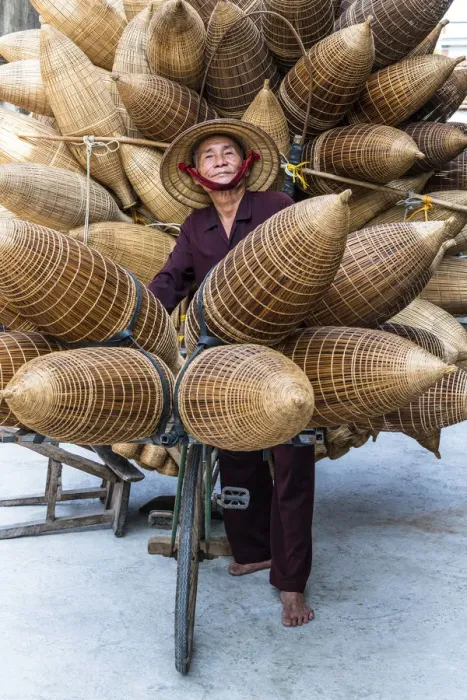 Framed Print : A portrait of a man on the bicycle loaded with the conical bamboo fish traps, near Hanoi Framed Print : A portrait of a man on the bicycle loaded with the conical bamboo fish traps, near Hanoi