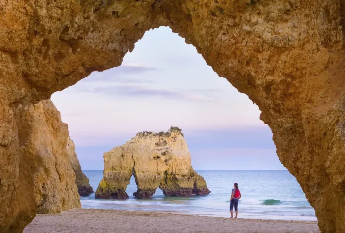 Framed Print : Portugal, Algarve, Alvor, Prainha, woman standing on beach (MR) Framed Print : Portugal, Algarve, Alvor, Prainha, woman standing on beach (MR)