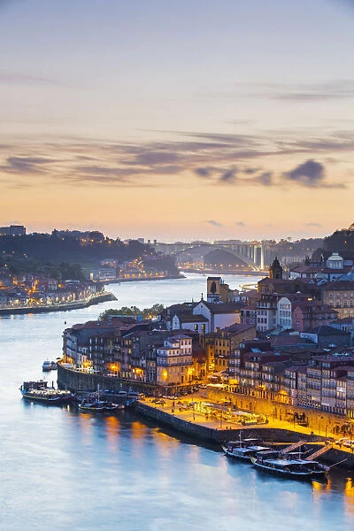 Portugal, Douro Litoral, Porto. Dusk in the UNESCO listed Ribeira district, viewed