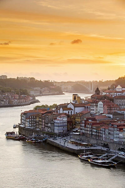 Portugal, Douro Litoral, Porto. Sunset over the UNESCO listed Ribeira district, viewed