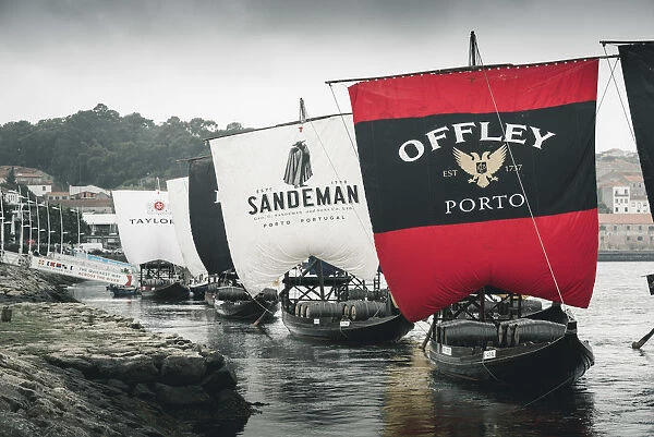 Portugal, Norte region, Porto (Oporto). Sailing boats showing porto wine brand names