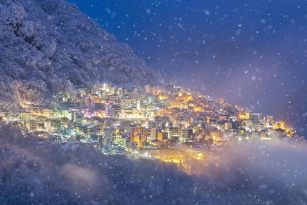 Premana at the blue hour in a snowy day, Valvarrone, Valsassina, Lecco Province, Lombardy