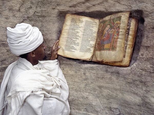 A Priest of the Ethiopian Orthodox Church reads a very old