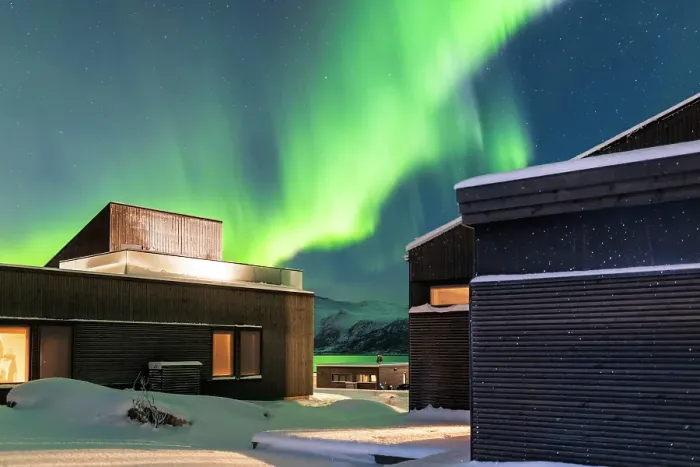 Framed Print : Private modern lodge near Svolvaer on a winter night with the Northern Lights in the sky and the color green reflecting in the fjords Framed Print : Private modern lodge near Svolvaer on a winter night with the Northern Lights in the sky and the color green reflecting in the fjords