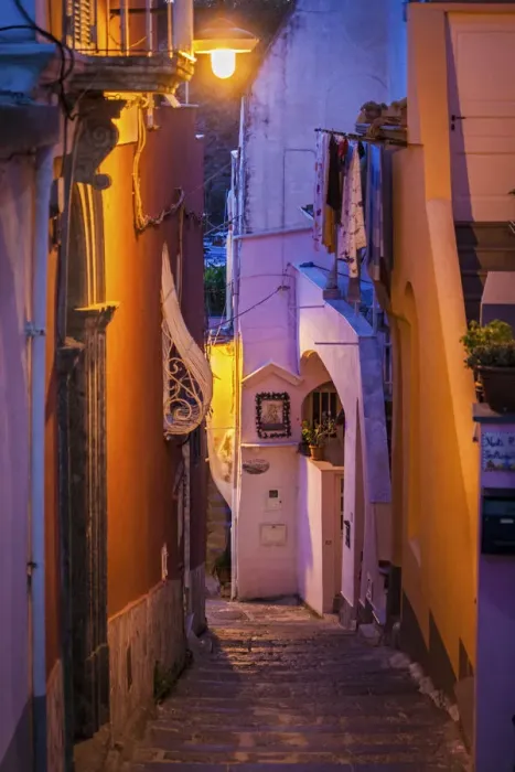 Framed Print : Procida island, Naples, Italy. A narrow street illuminated at dusk Framed Print : Procida island, Naples, Italy. A narrow street illuminated at dusk