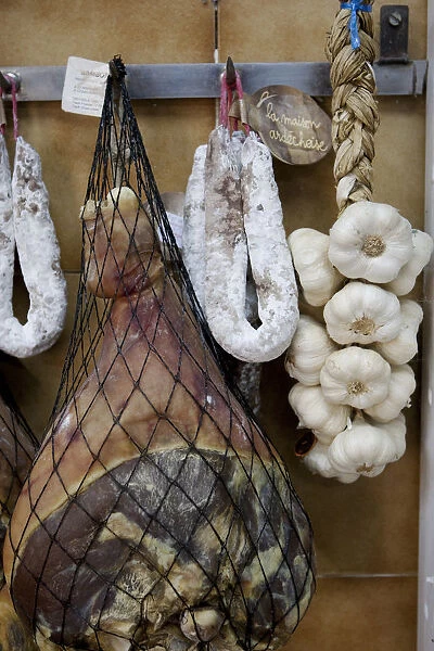 Provence, France. Meat hanging with garlic in a traditional deli in the South of France