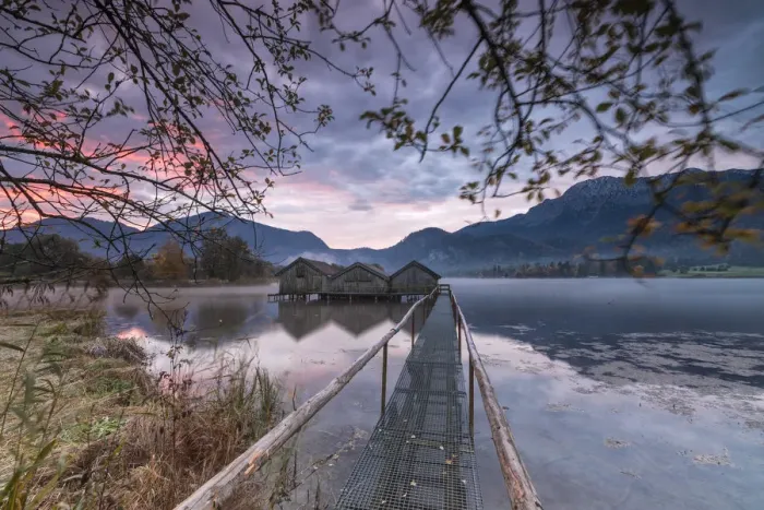 Framed Print : Purple sky at sunset and wooden huts are reflected in the clear water of Kochelsee Framed Print : Purple sky at sunset and wooden huts are reflected in the clear water of Kochelsee