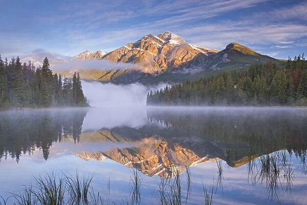 Pyramid Mountain reflected in Pyramid Lake at dawn on a misty morning, Jasper National Park