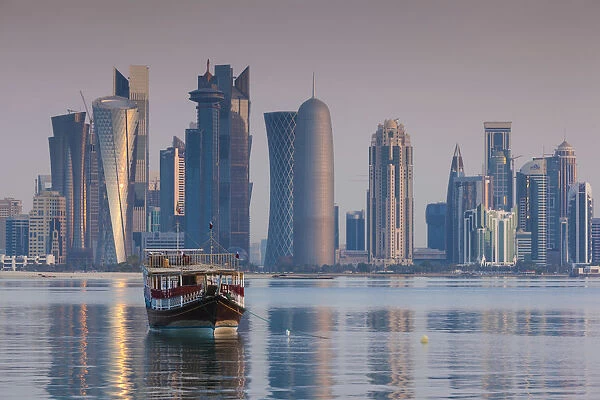 Qatar, Doha, Dhows on Doha Bay with West Bay skyscrapers, dawn