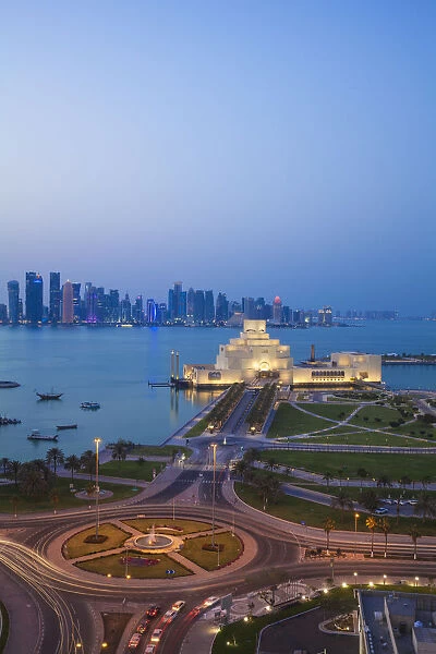 Qatar, Doha, Traffic at roundabout infont of the Museum of Islamic Art at night